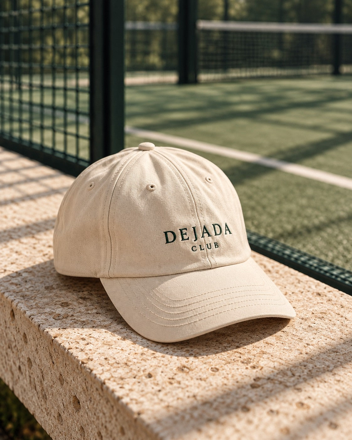 Dejada Club cap on a courtside bench